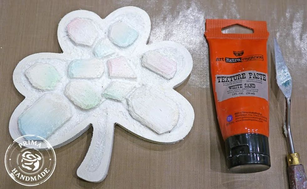 Apply white sand texture paste around geo shapes.