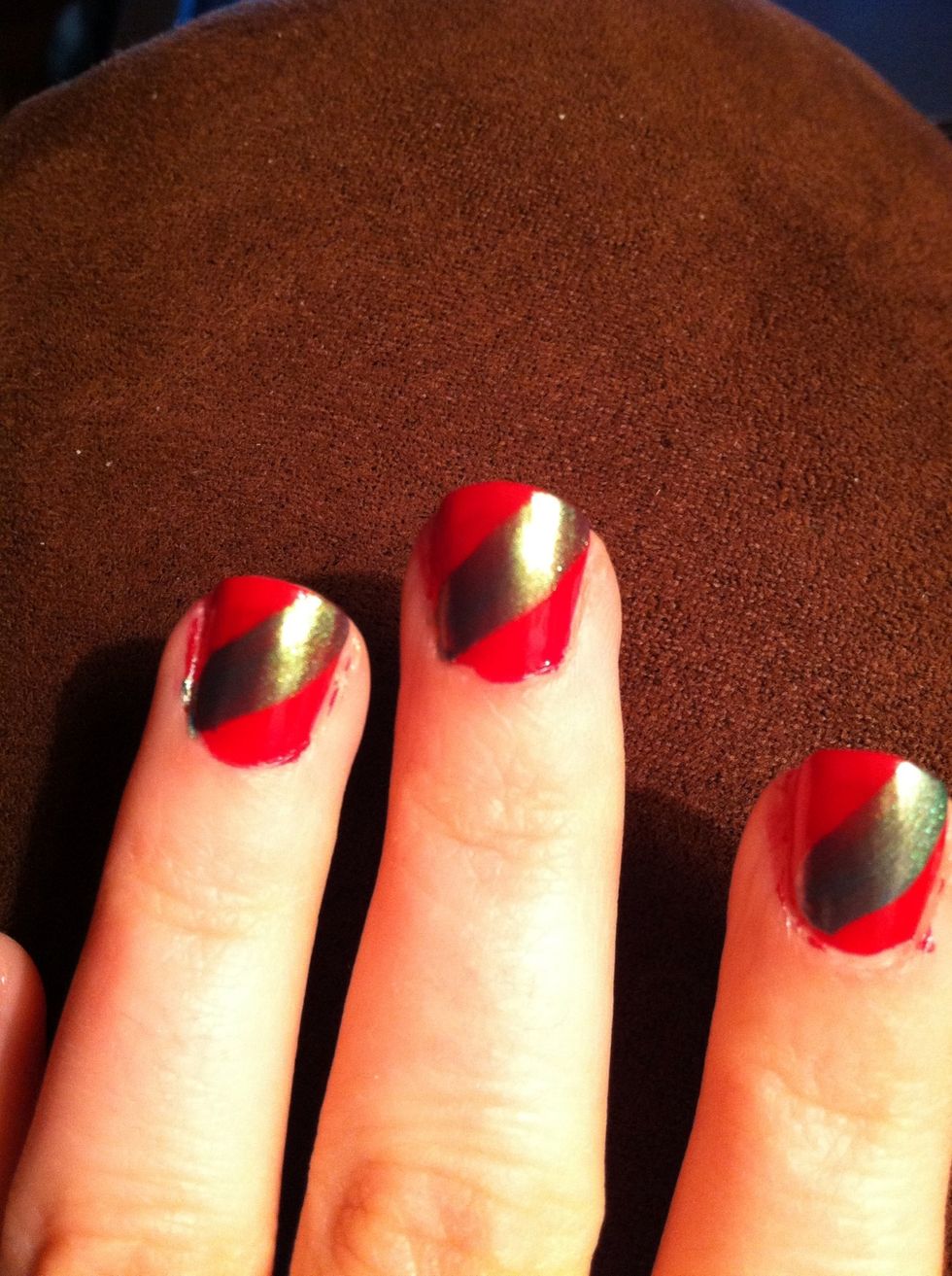 Apply with one stroke of the green polish to nail. Starting with the left hand, sweep brush from bottom left of the nail to top right of the nail.