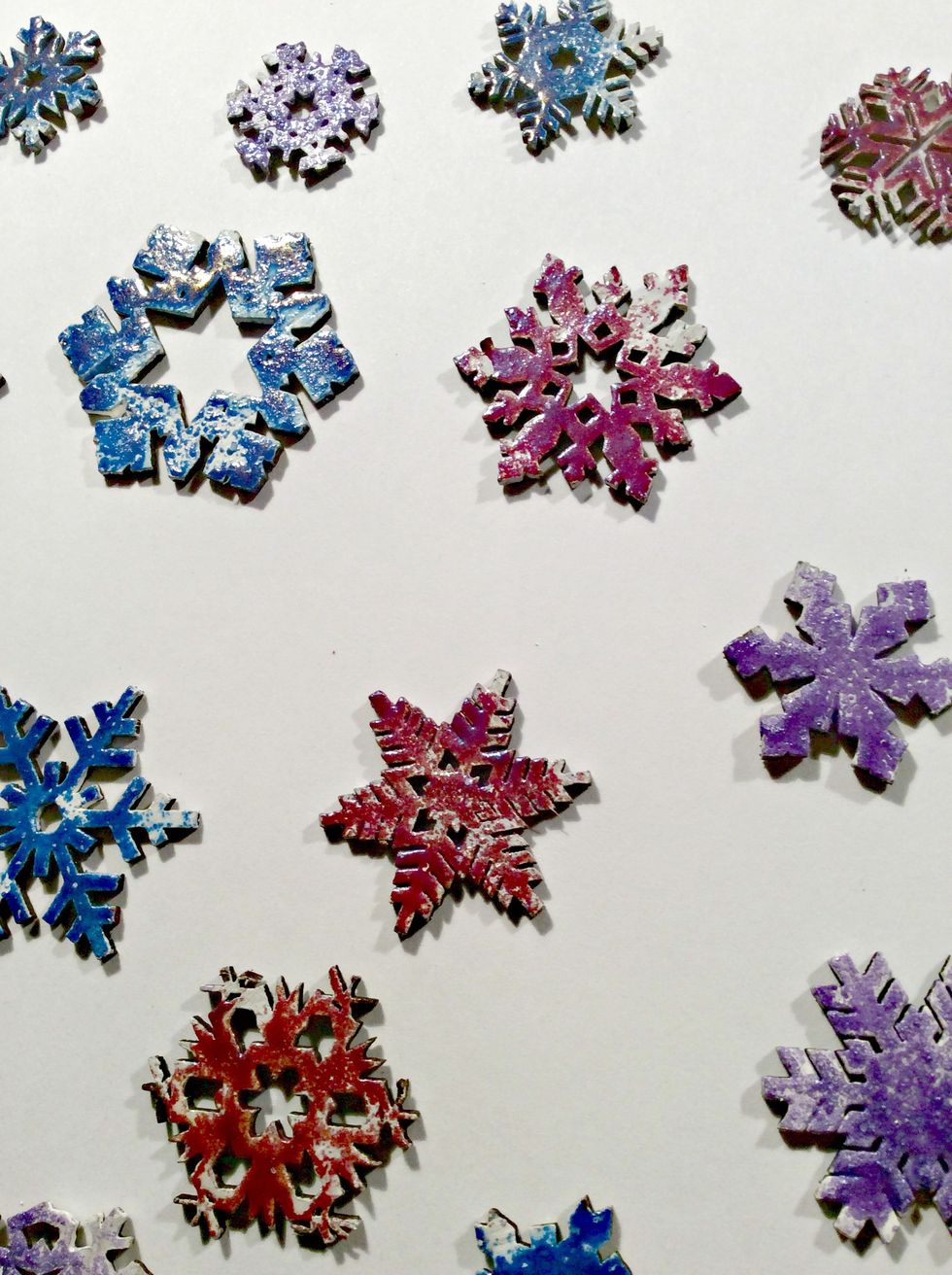 Apply your colored embossing powders and using your finger, rub off some of the powder so that it heats up sporadically. Gives a distressed look.