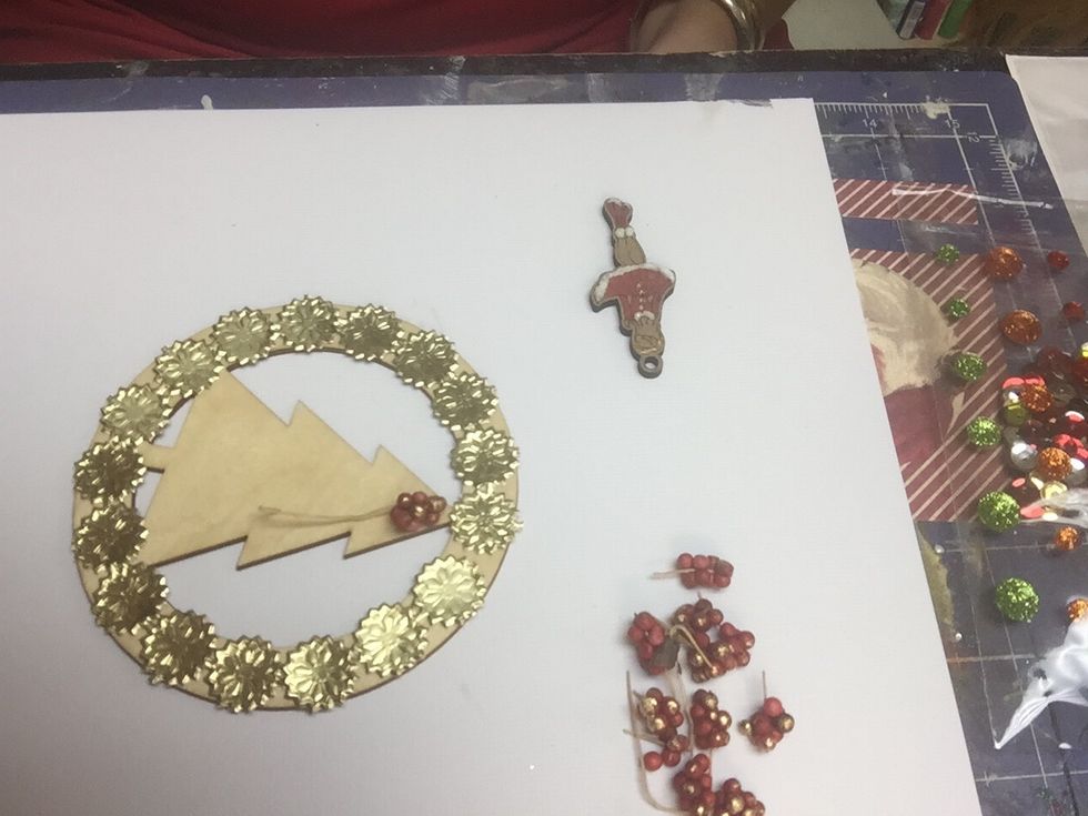 Apply your Dresden Trim in your wood circle and begin covering your tree with the berries