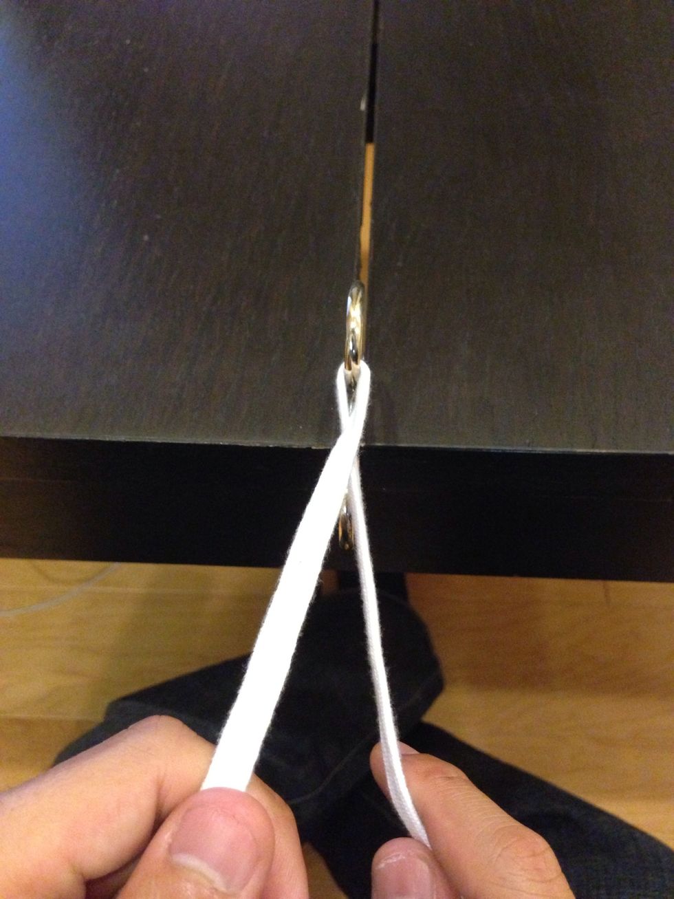 Apply your practice "suture" to a hook or ring. Decide on which hand will perform the two hand tie. This is the "throwing" hand. (It holds the fixed end and throws the free end through the loop).