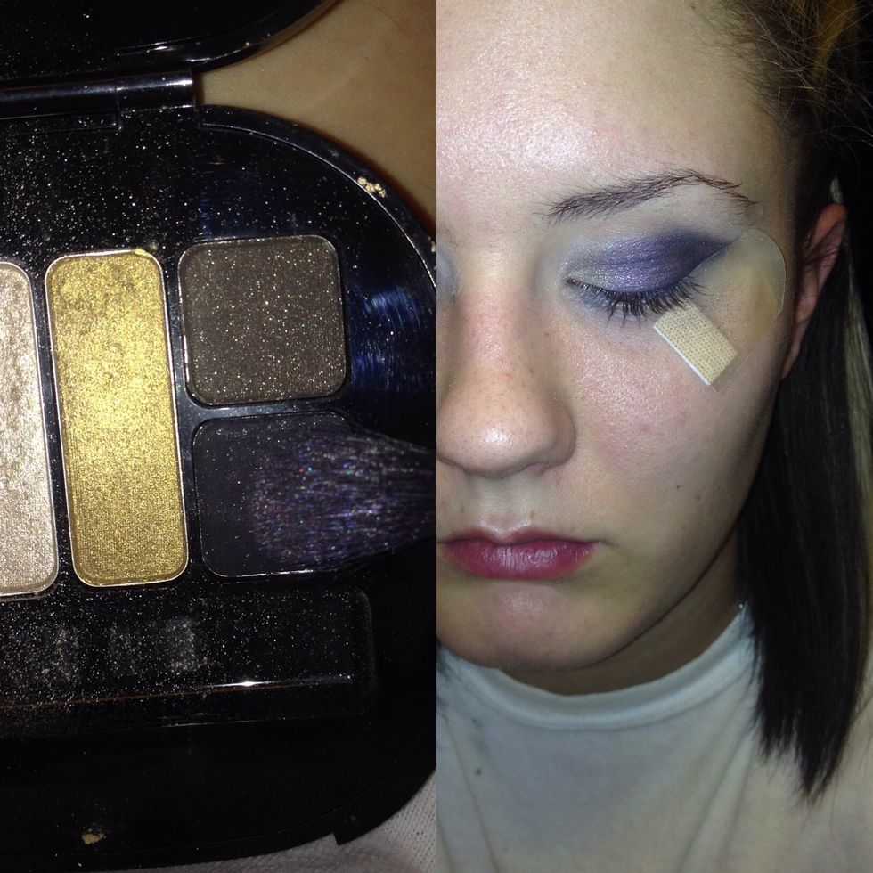 Apply your purple then using your blending brush apply black to your outer crease