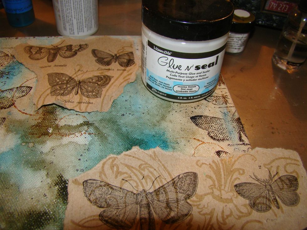 Apply your ripped sheets with Glue N Seal. You can also use Mod Podge. Don't forget to let some of the papers run over the edge of the canvas. We don't want to forget to decorate the edges.