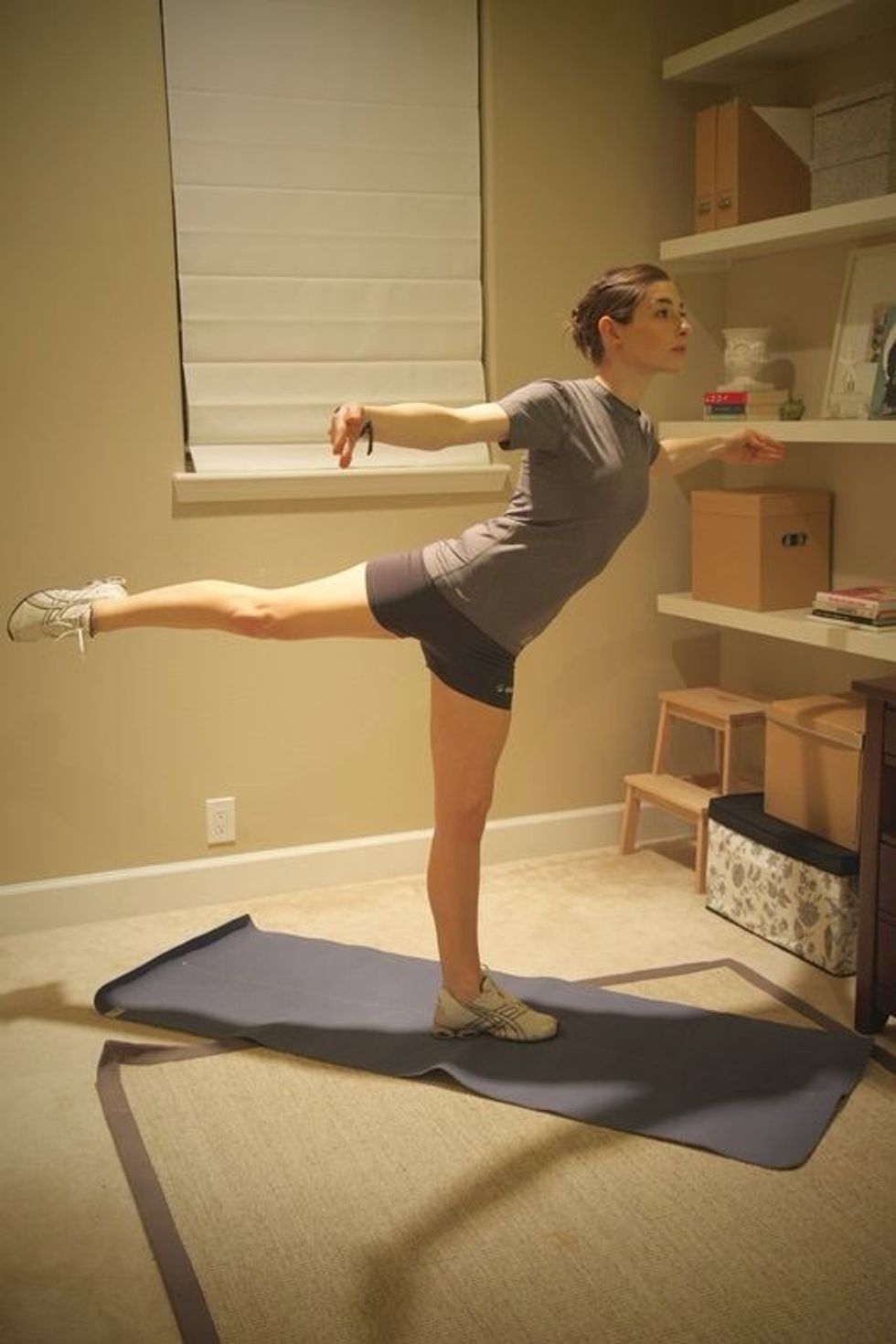 Arabesque Back: lift pointed leg behind you while keeping torso up and hips even. Hold for 4 counts, then continue with front, side, and back for 1 min with right leg and 1 min with left.