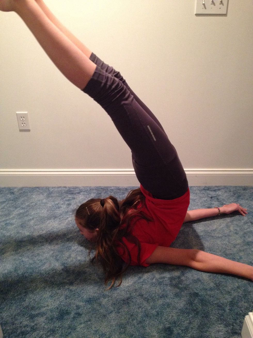 Arch, and then propel yourself forward, rolling through you body, until your feet are over your head. It might take a few tries at first.