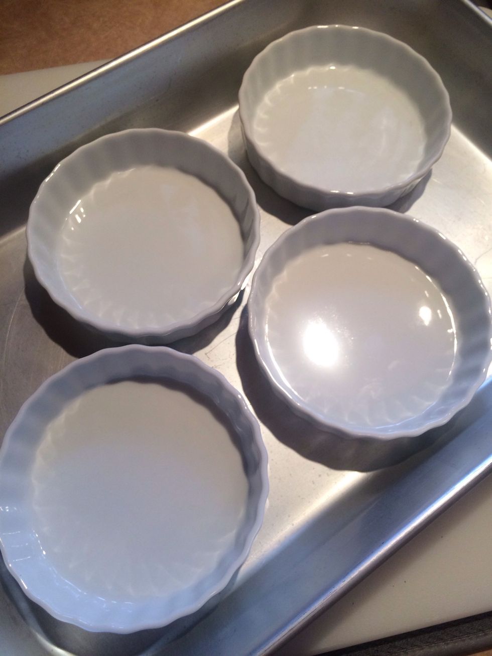 Arrange custard dishes in a small roasting pan, 9x13 glass pan or even a lasagna pan.