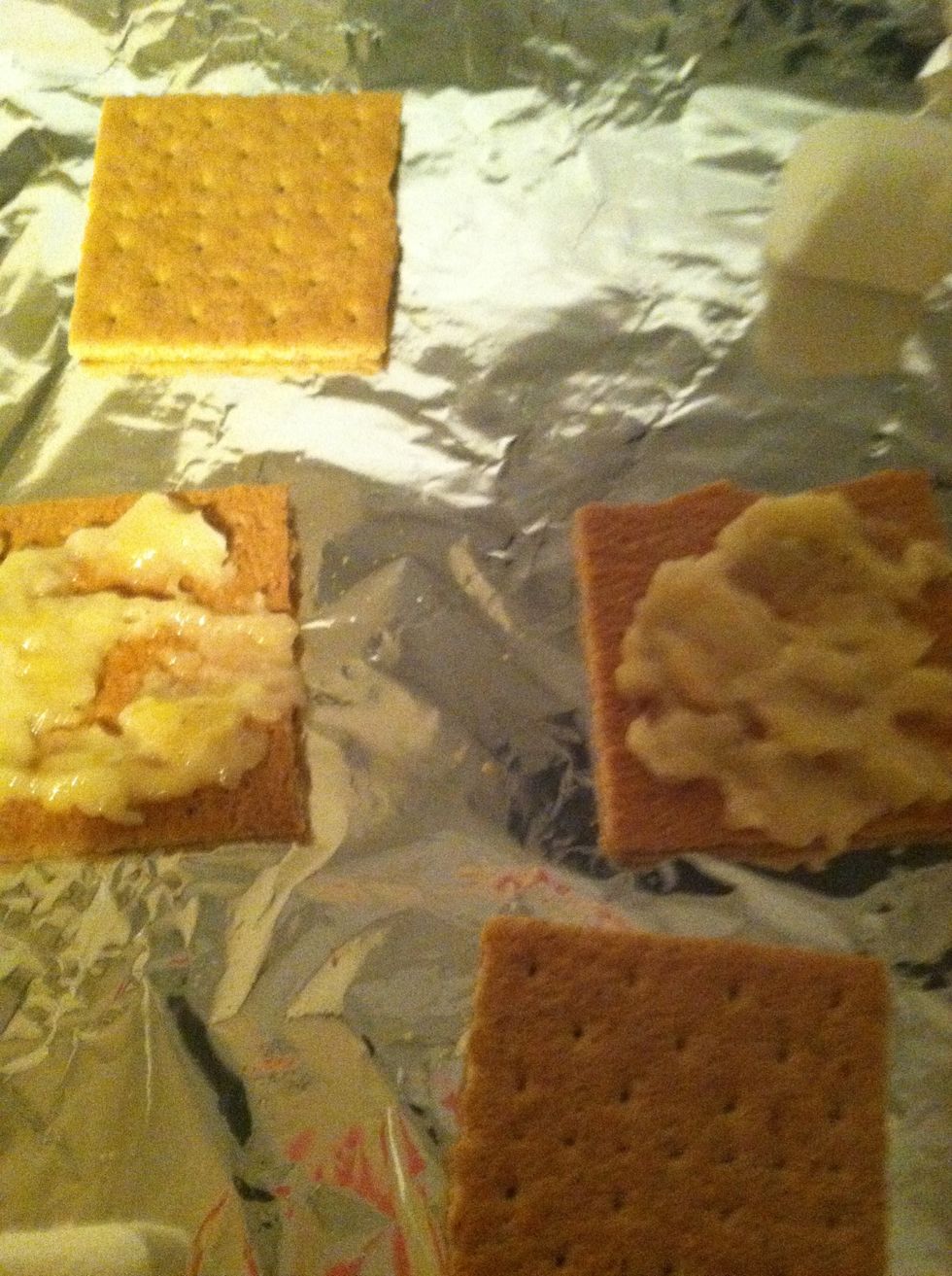 Arrange Graham Crackers On Pan and Spread banana slice on graham cracker