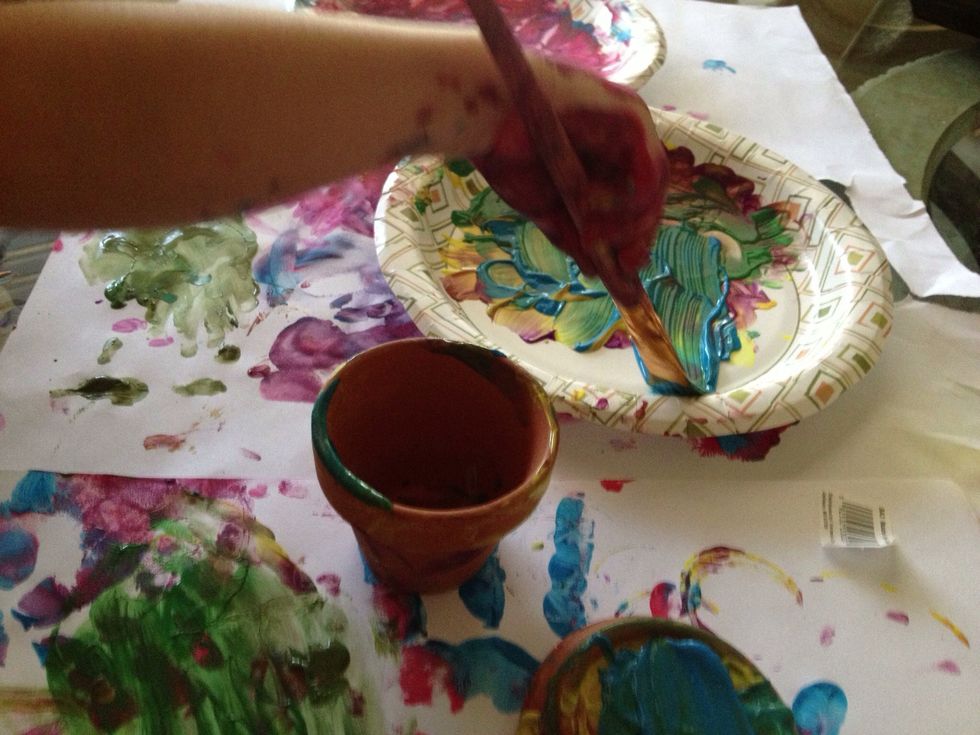 Arrange large sheets of paper to cover the area where you are painting. Squeeze paint onto paper plates. Let the painting begin!