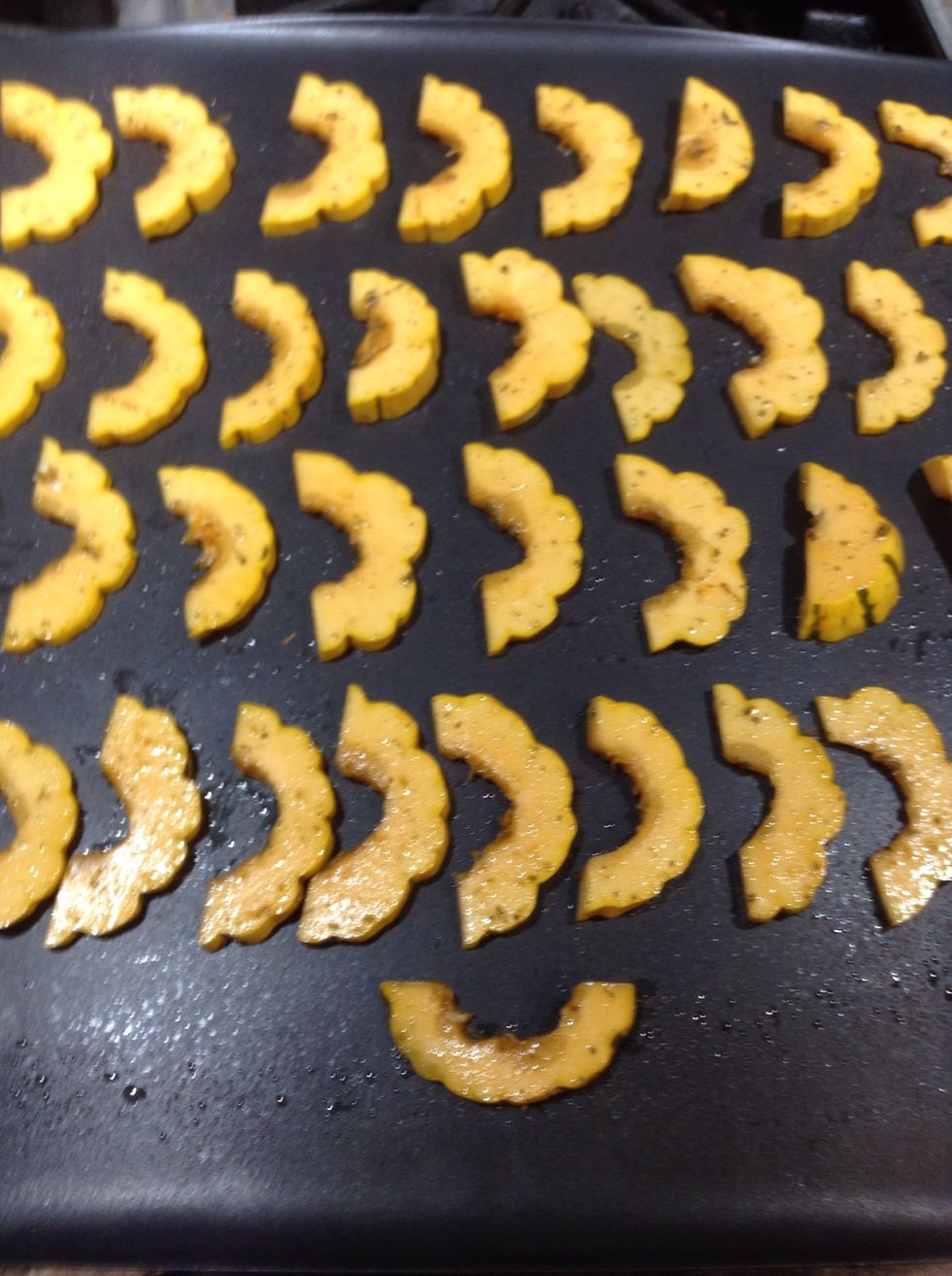 Arrange squash slices on a lightly oiled cookie sheet and bake in the 375F oven for 15 minutes. Remove when done and set aside.