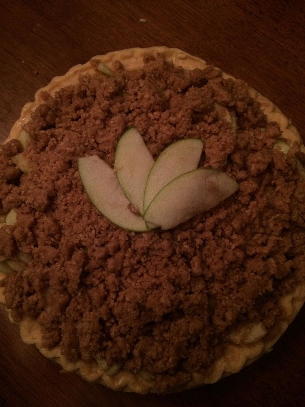 Arrange the apples we set aside earlier in a semicircle type shape. You can do this either before you bake the pie or directly before you serve the pie with fresh apple slices. I did it before baking.