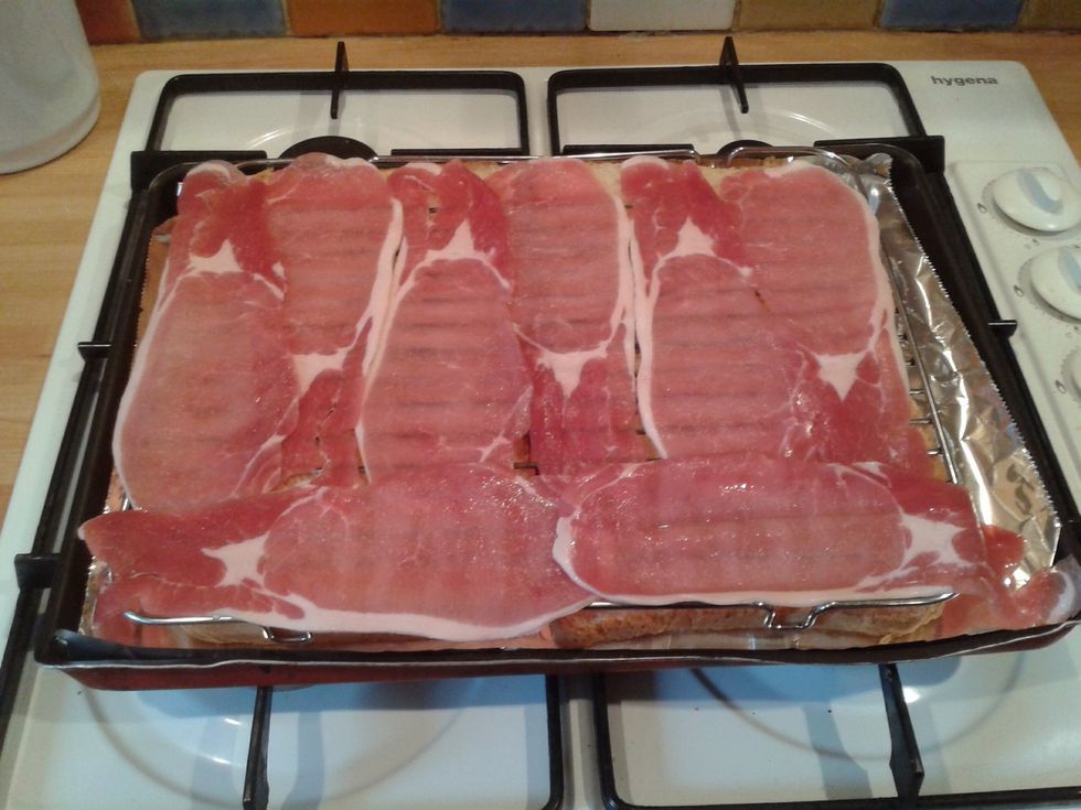 Arrange the bacon slices to cover the wire rack.