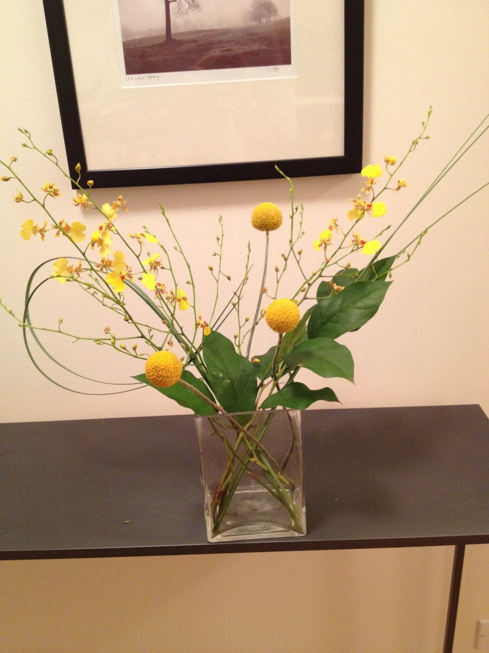 Arrange the craspedia at varying heights and angles. Congrats, you finished the first arrangement! Now, on to the 2nd.