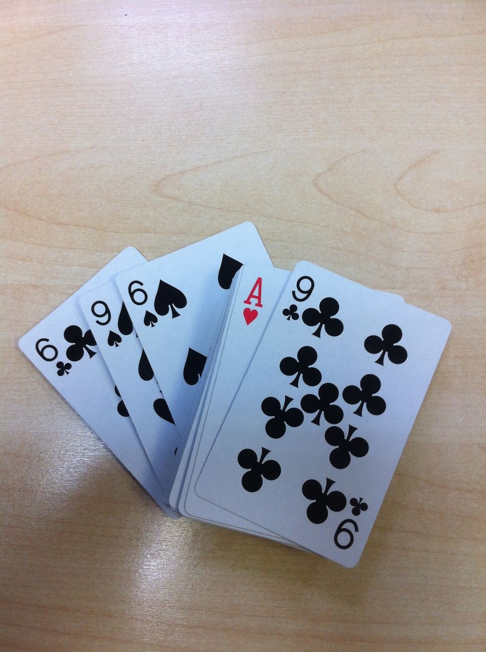 Arrange the six and nine of clubs and spades as shown here.