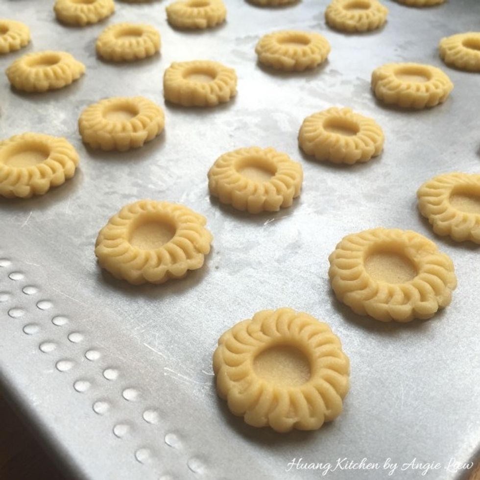 Arrange the stamped tart shells onto a baking tray.