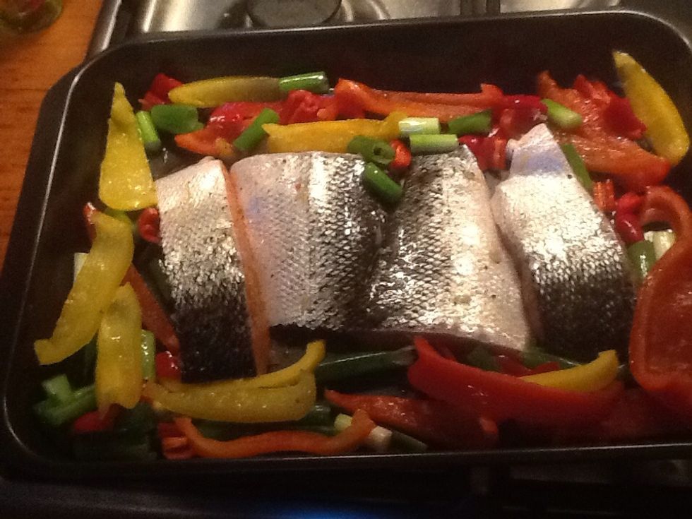 Arrange the vegetables around the salmon with the skin up. Put the salmon under the grill on the middle shelf for 14 minutes.