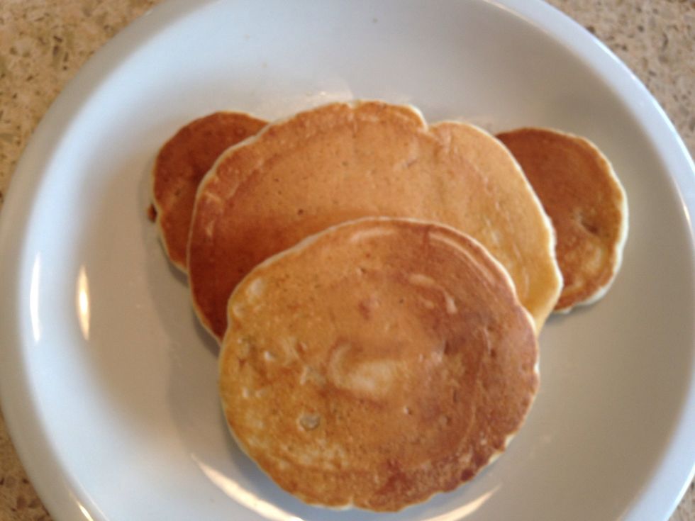Arrange two small pancakes as ears, layer on top large pancake for head, then layer medium size pancake for the nose as the top layer of the stack.