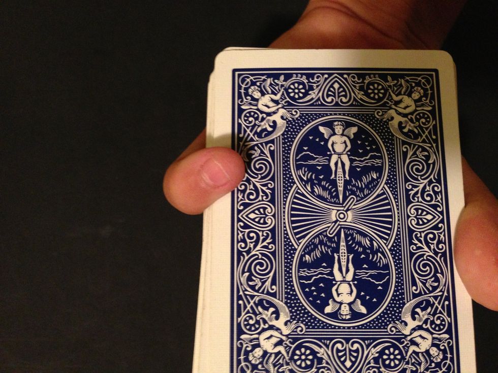 As shown here keep your finger just enough so the spectator won't suspect anything.