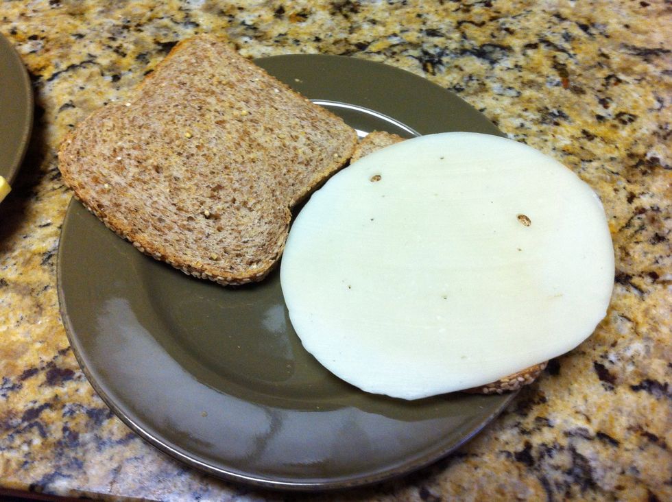 As soon as bread is finished, immediately plate and add cheese slice. Hot toast will help melt cheese.