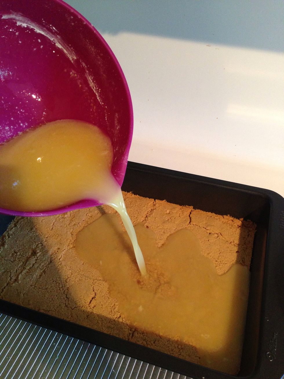 As soon as crust is done, reduce the temp to 300 degrees and pour lemon mixture over hot crust. Place in oven for about 20-30 minutes, or until edges are golden and are starting to separate from pan