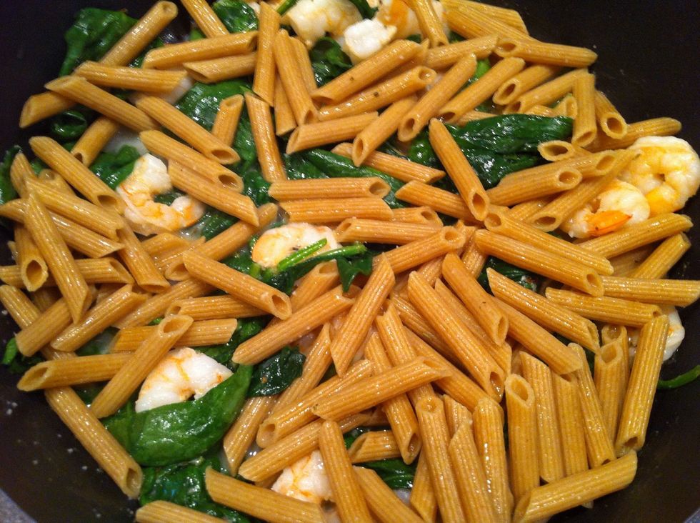 As soon, as spinach starts shrinking, add cooked and drained pasta. Mix it up. You might wanna add garlic.