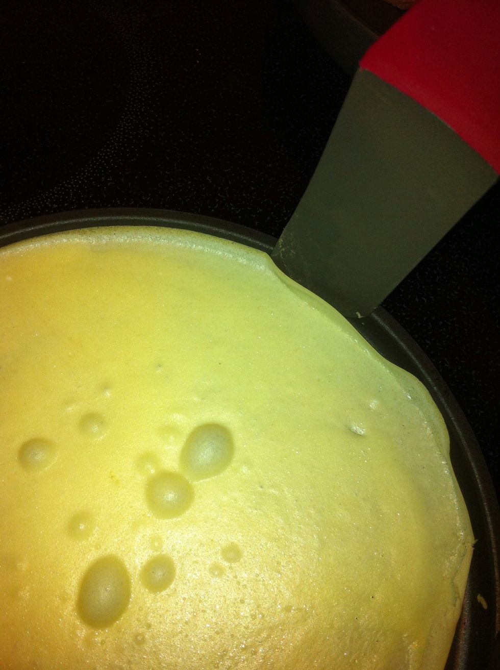 As soon as you start to see the very edges of the crepe turning light brown, run the edge of the spatula around the crepe and loosen it from the pan.