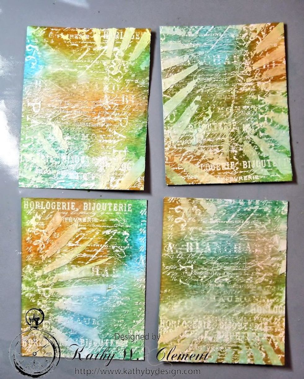 As the background dries, the ink colors will seep into the texture paste. Cut the dried background into 4 even rectangles. Each piece is a card base. Now that wasn't so hard, was it?