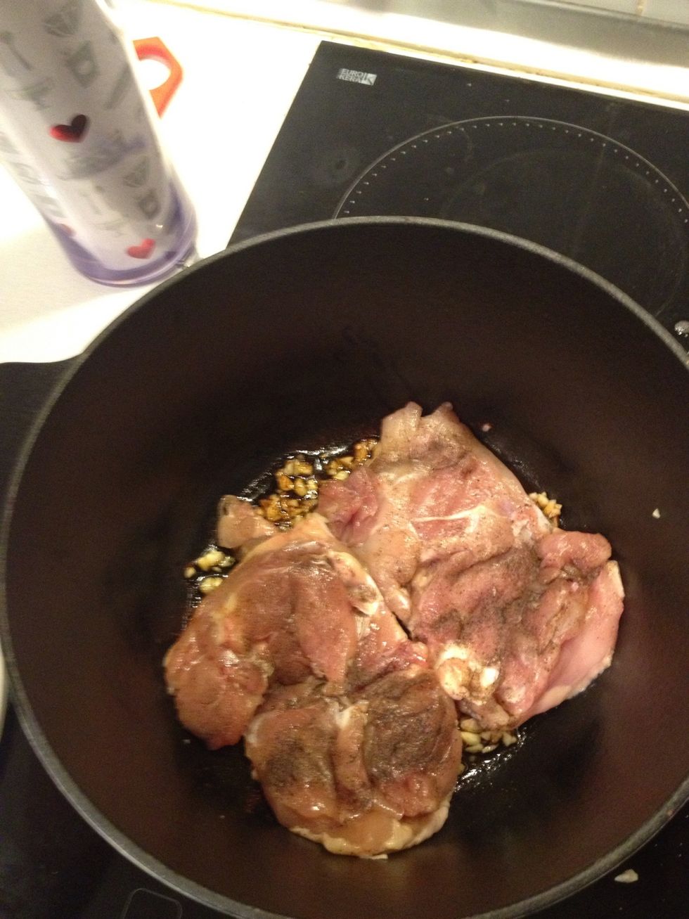 As the casserole's warming up, Put the chicken in skin side down.