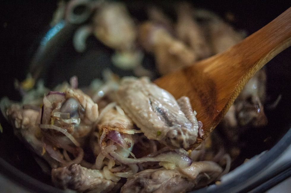 As the chicken starts to brown, stir the onions to also start the browning process