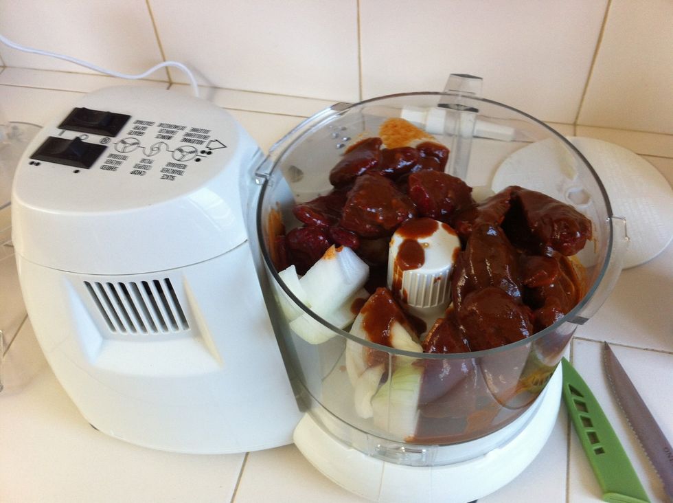 As the pork simmers cut up 1/2-3/4 of your onion and place it in your food processor. I live in Hawaii and couldn't find dry chillies, so I'm adding 2 small cans of chipotle instead.