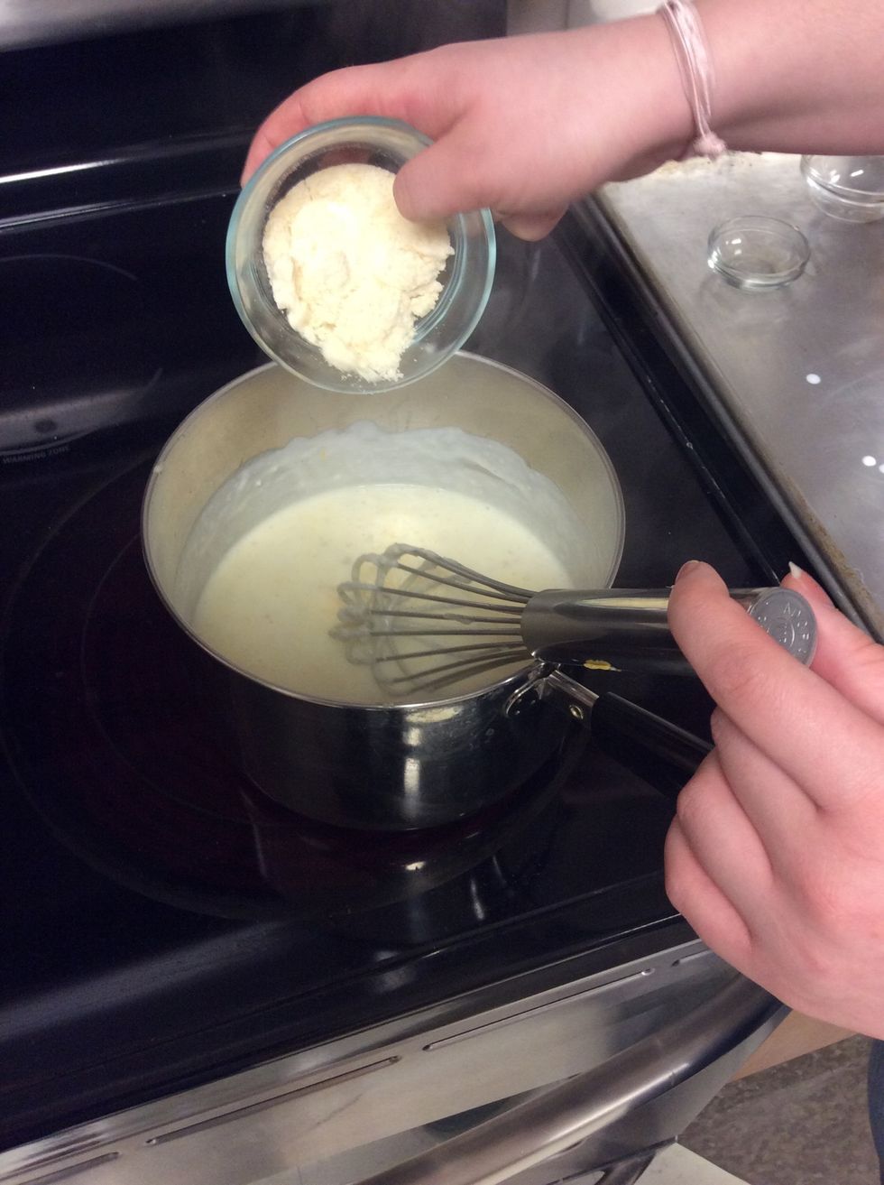 As you add the cheddar also add 1 oz of grated Parmesan. Add both the cheddar and Parmesan in three batches while continuing to whisk.