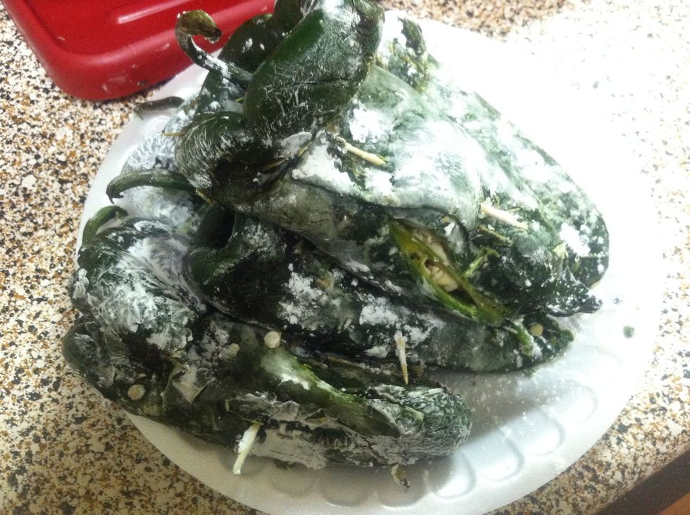 As you can see i used a toothpick close the peppers back up. When the pepper is stuffed cover them with flour. This will help the egg stick to the pepper.