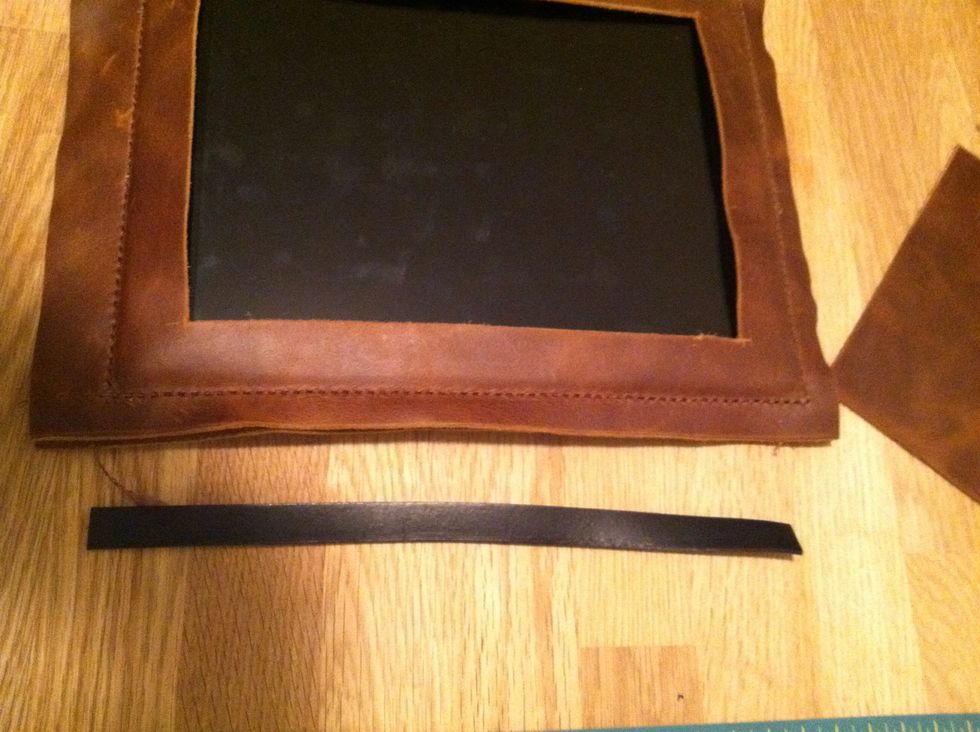 As you can see the porthole leather is a little floppy. So, we need to reinforce The border. I found some leather that is pretty thick. I will cut it to fit around the view hole. It's about 1cm wide.