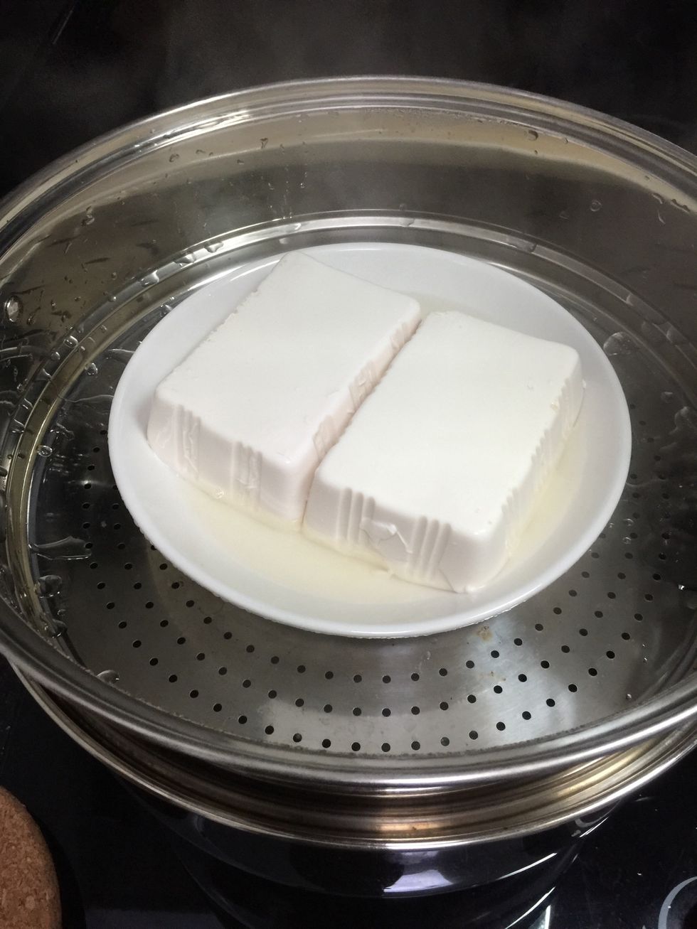 As you can see there's water after steaming the tofu, discard the water.