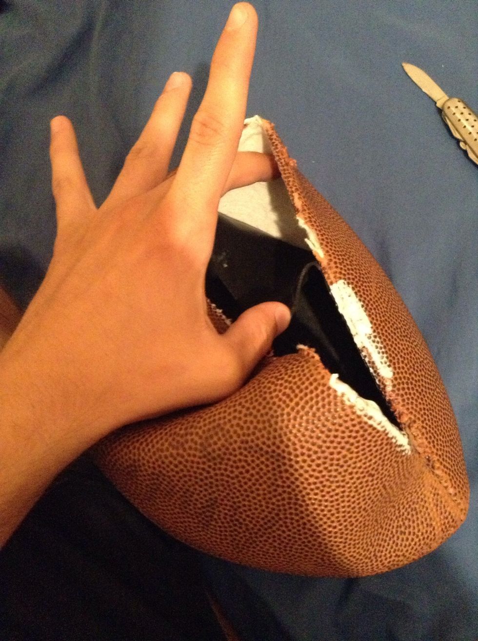 As you can see..when you cut through the lacing..you also cut through another layer of the football..the leather on the outside is seperated from the rubber in the inside.