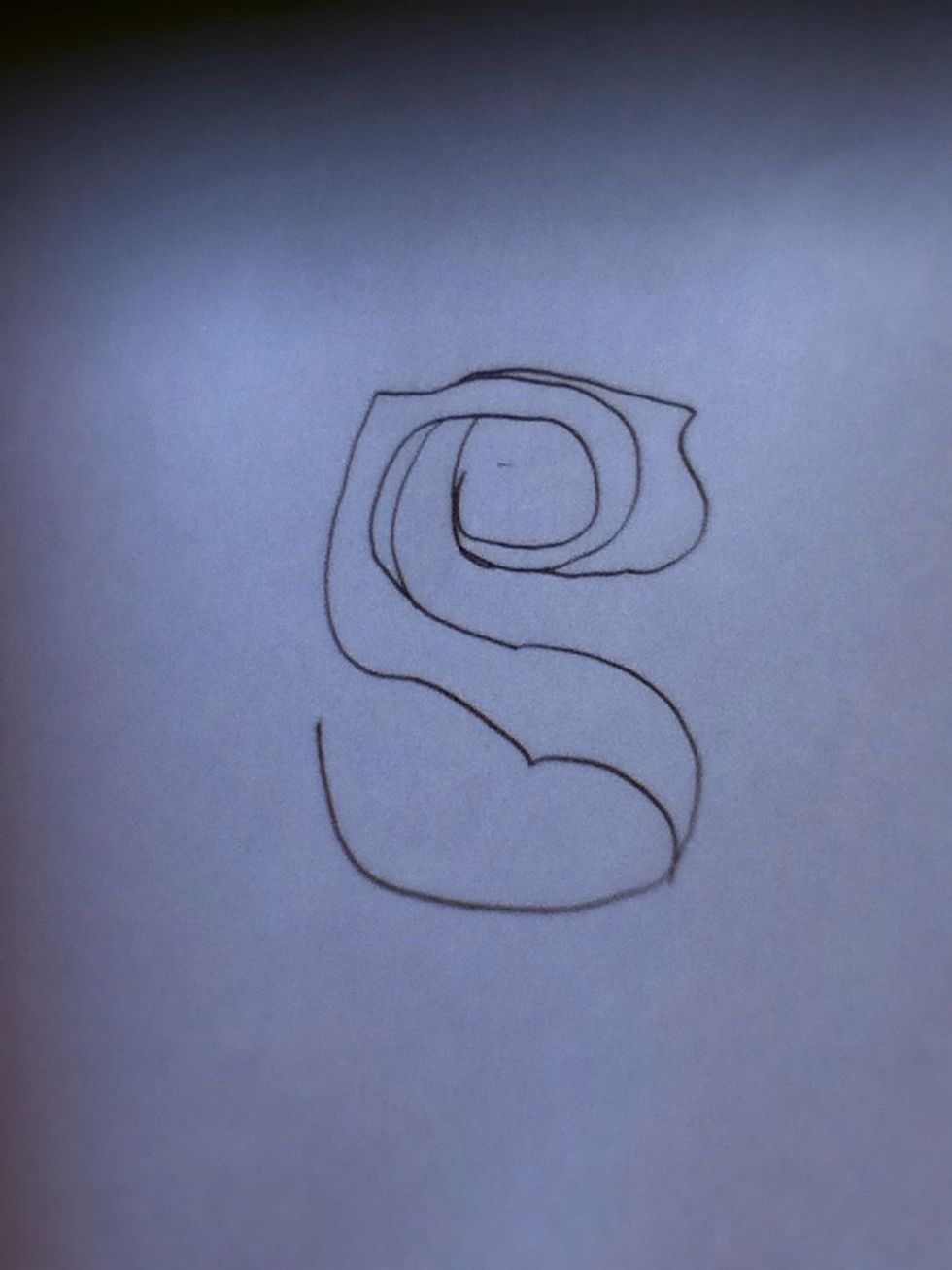As you continue to shape your petals, you'll start noticing how the S will later transform into a rose.