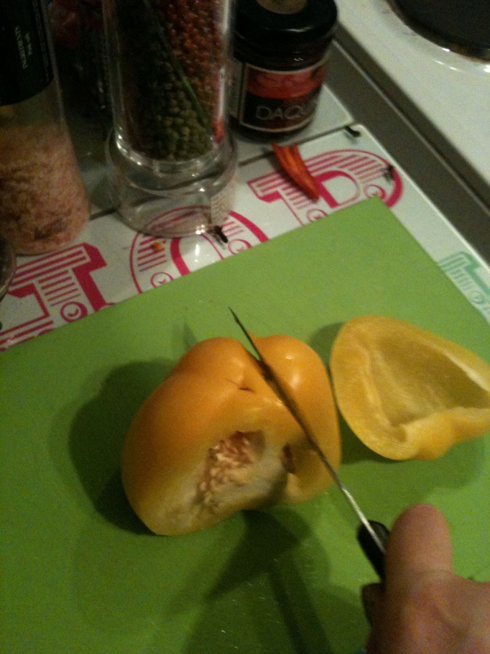 As you cut the pepper, following the section divides, you'll see that the pepper that's cut off has no white pith or seeds attached.