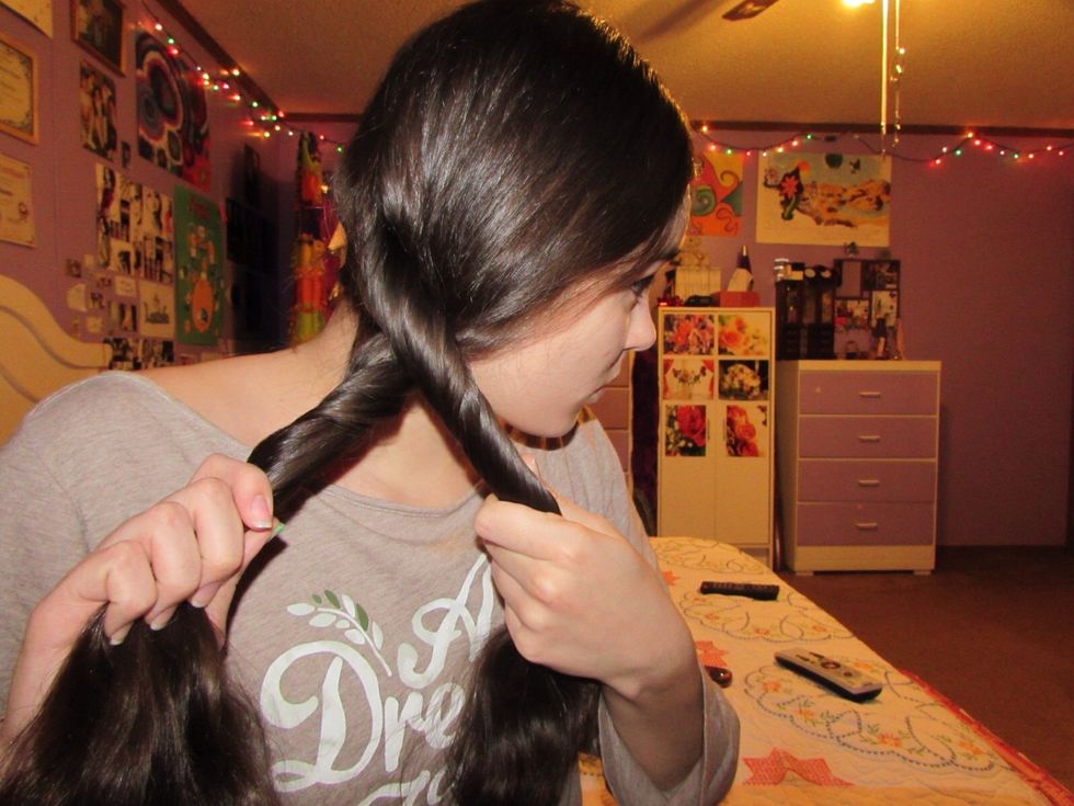 As you have your two sections twisted away from your face, twist them together towards your face. Twist away and together!