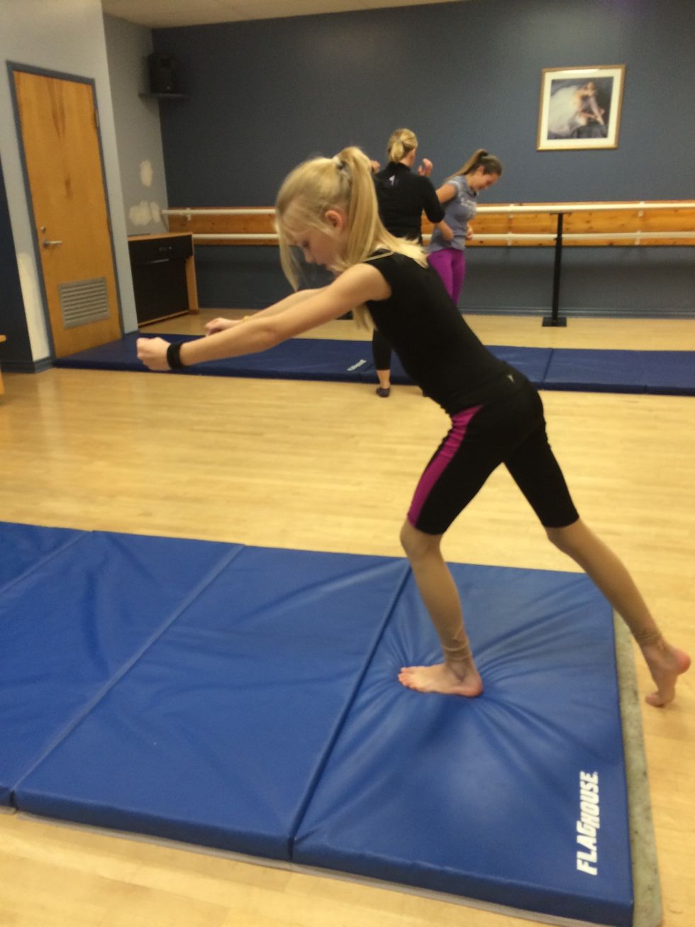 As you land whip your arms behind you and whip your legs up