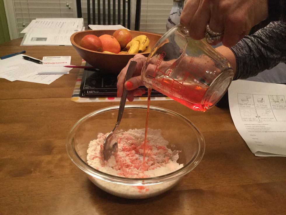 As you pour, stir the mixture until all elements are completely combined.