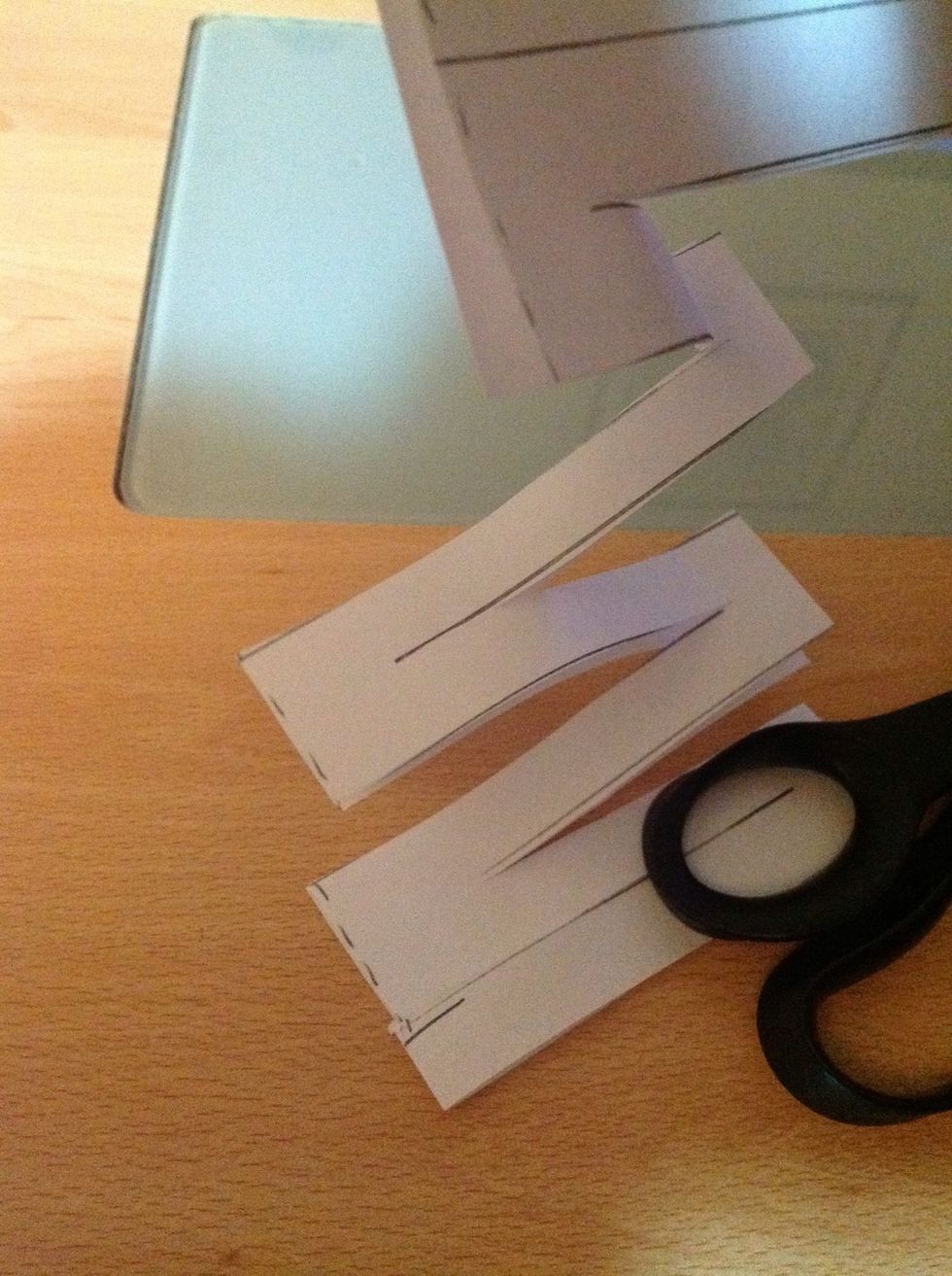 As you start to cut the paper, it will start to look like this. You can start to see that it remains as one sheet of paper, but with a large hole in the middle.