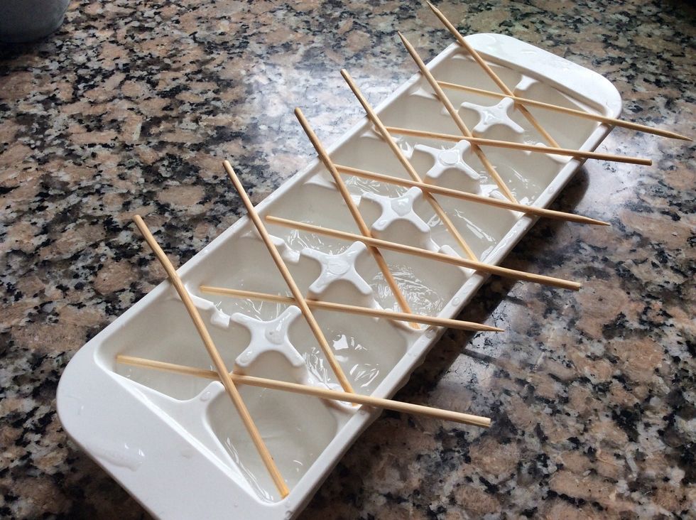 As your liquid approaches the deep golden stages, prepare your now frozen ice cube trays with bamboo lollypop sticks.  I was a bit slow with this and my toffee went slightly over temp.
