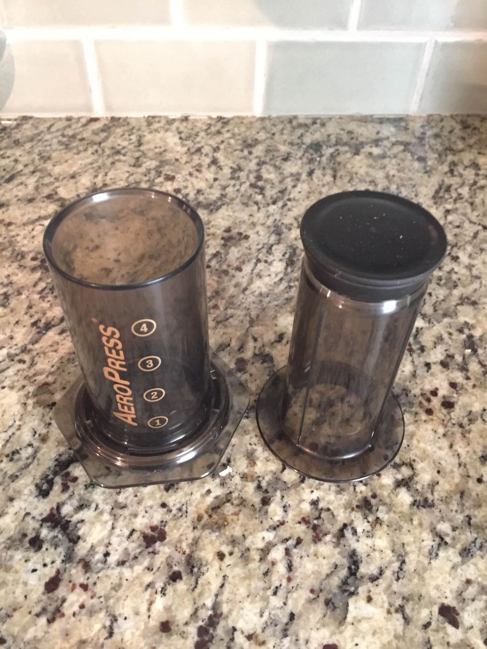 Assemble the coffee maker by placing a filter in the cap and screwing it on the bottom.