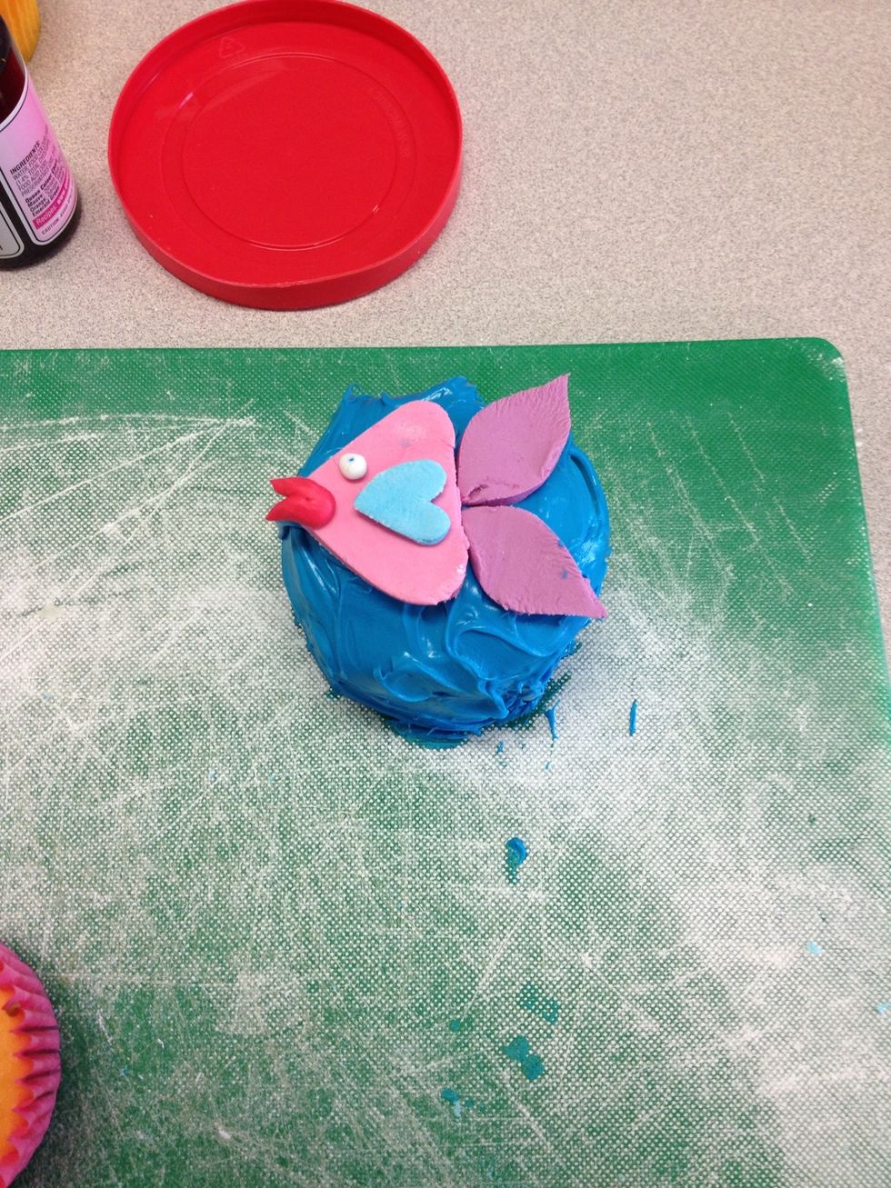Assemble the fondant shapes on top of the cupcakes, make the lips out of extra fondant with more dye