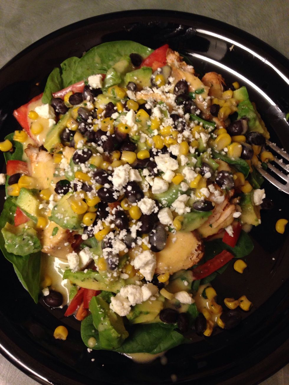 Assemble the salad (greens, chicken, avocado, tomato, beans/corn, feta) then top with the dressing. Bon appetit!