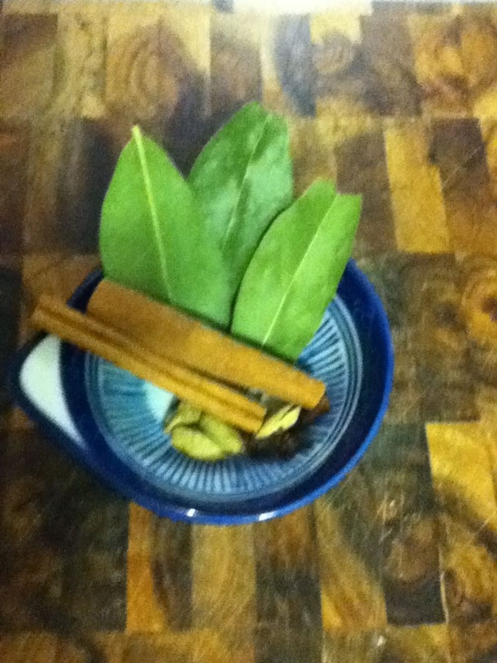 Assemble yer whole spices: three bay leaves, two cinnamon sticks, four cloves, four pods of cardamom smashed open.