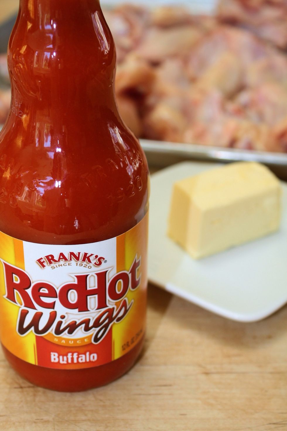 Assemble your ingredients. You'll need your favorite wing sauce and whole butter. The butter is key as it not only provides richness but also helps temper the hot sauce heat.