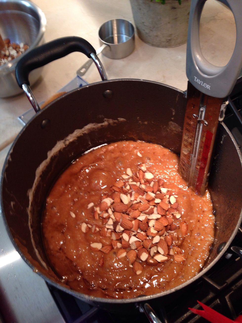 At 300 degrees add the 1 cup of raw chopped almonds. This will drop the temperature but standby - remove immediately at 305.