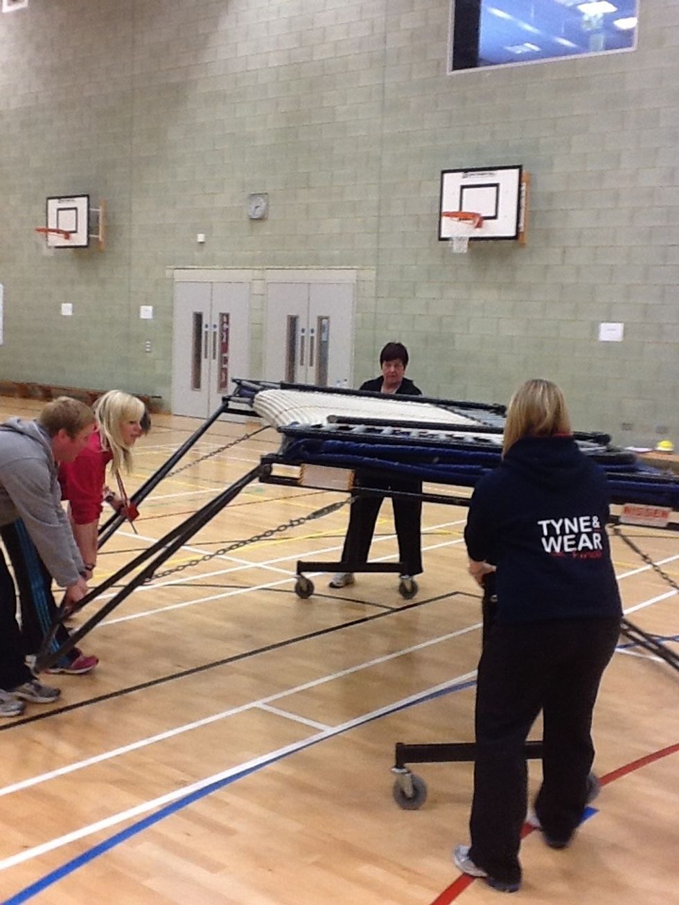 At least 2 people are required to lift the trampoline, whilst another 2 people remove the wheels. Lift by bending your knees and keeping your back straight! remember to keep fingers and toes clear!