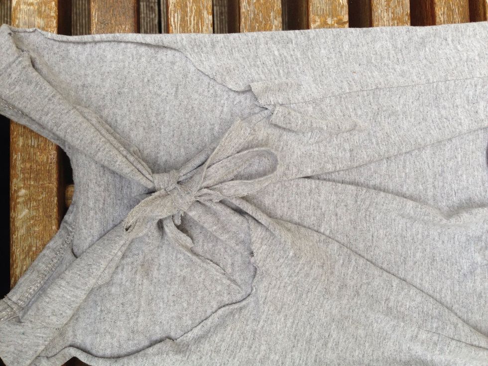 At the back, tie a bow or knot with the material.