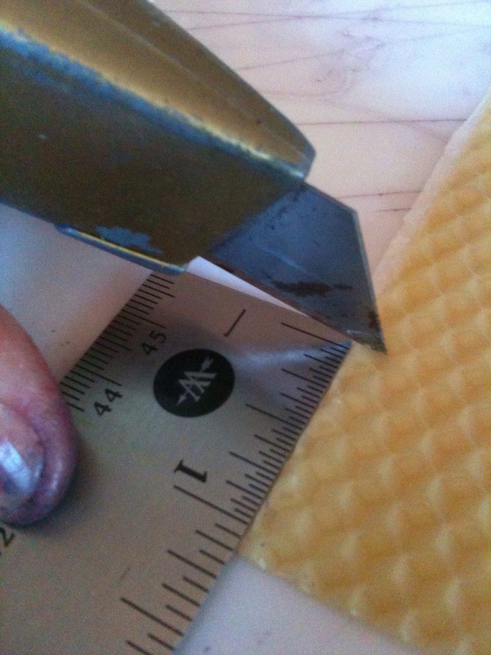 At the bottom left corner, measure 1 inch from the bottom and mark with a small slit.